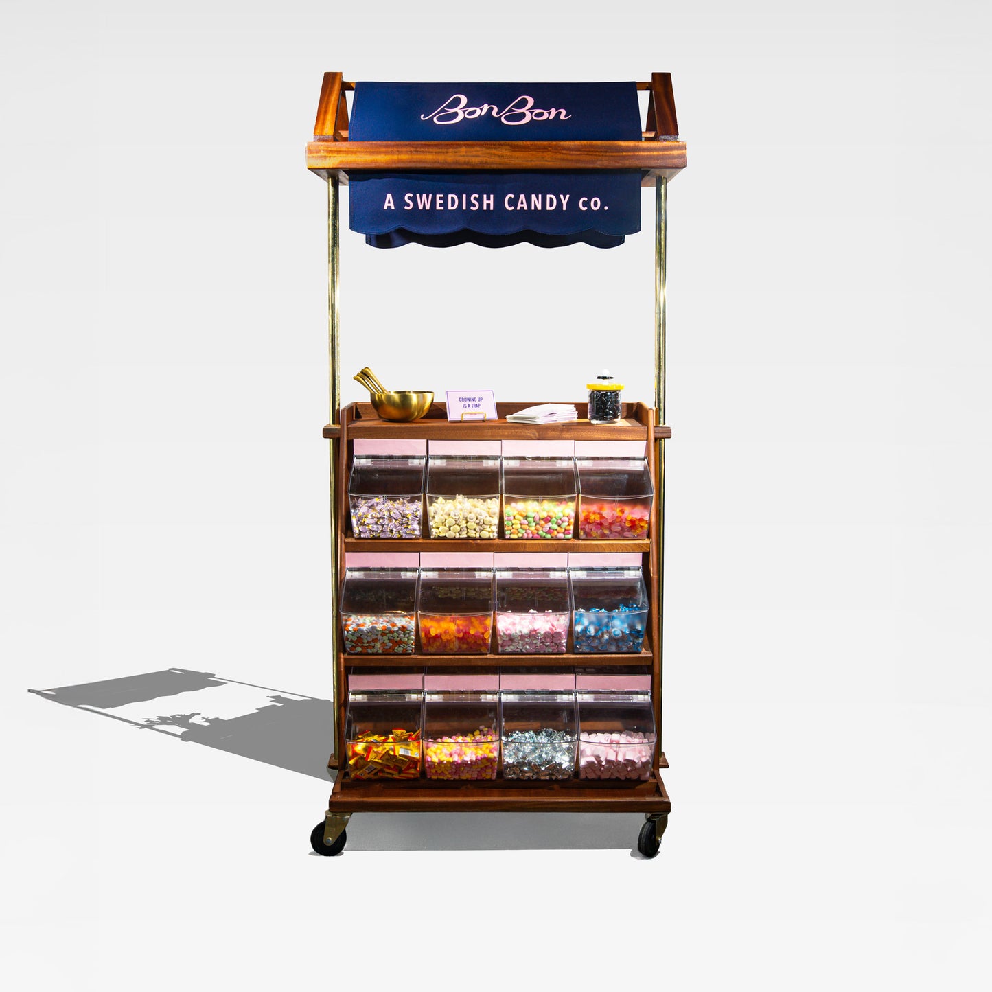 The BonBon candy cart: walnut wood, brass poles and a navy scalloped awning