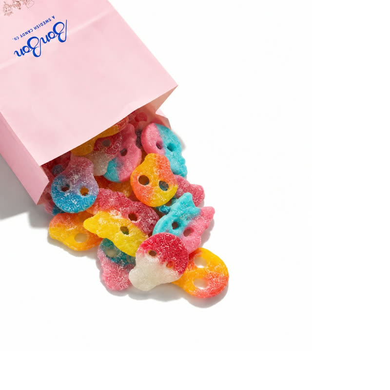 A pink BonBon candy bag spilling Sour Skulls Mix